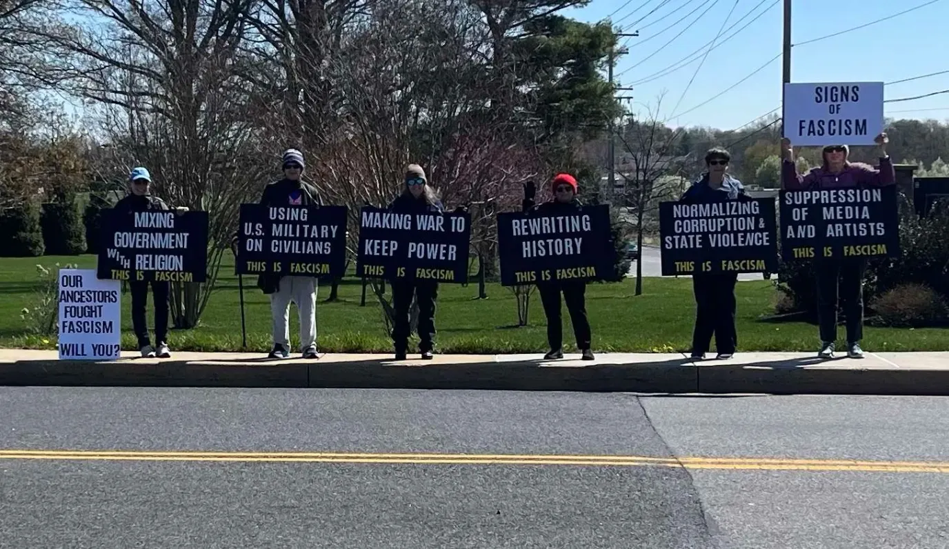 Volunteers holding Signs of Fascism protest signs along a Harford County road.